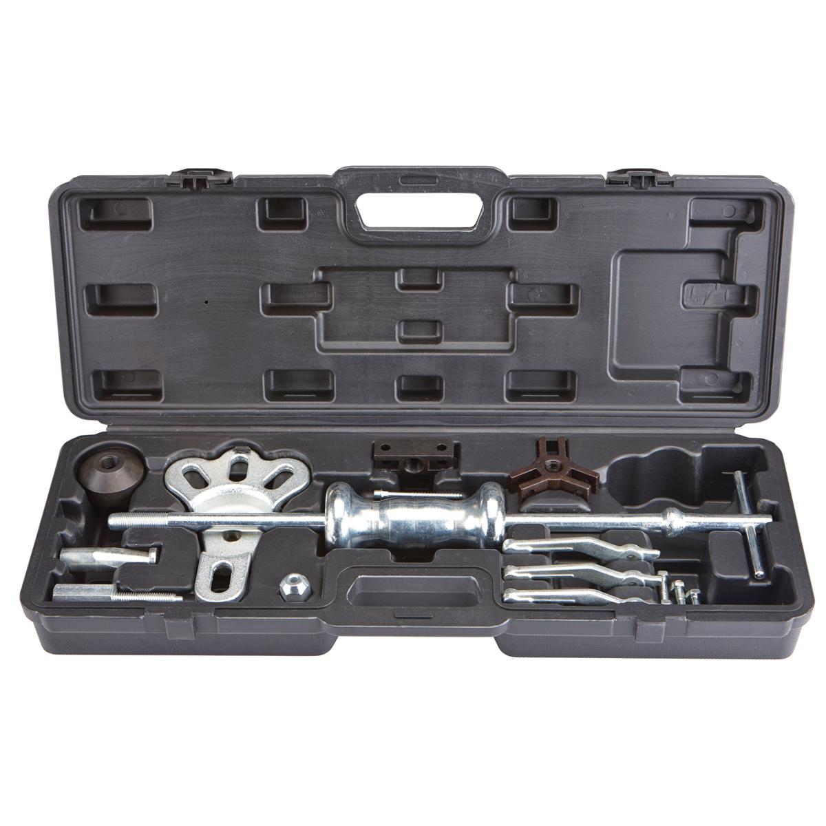 Mechanic specialty tools set — bearing pullers, spring compressors, timing tool kits, and seal drivers organized on pegboard in a professional workshop