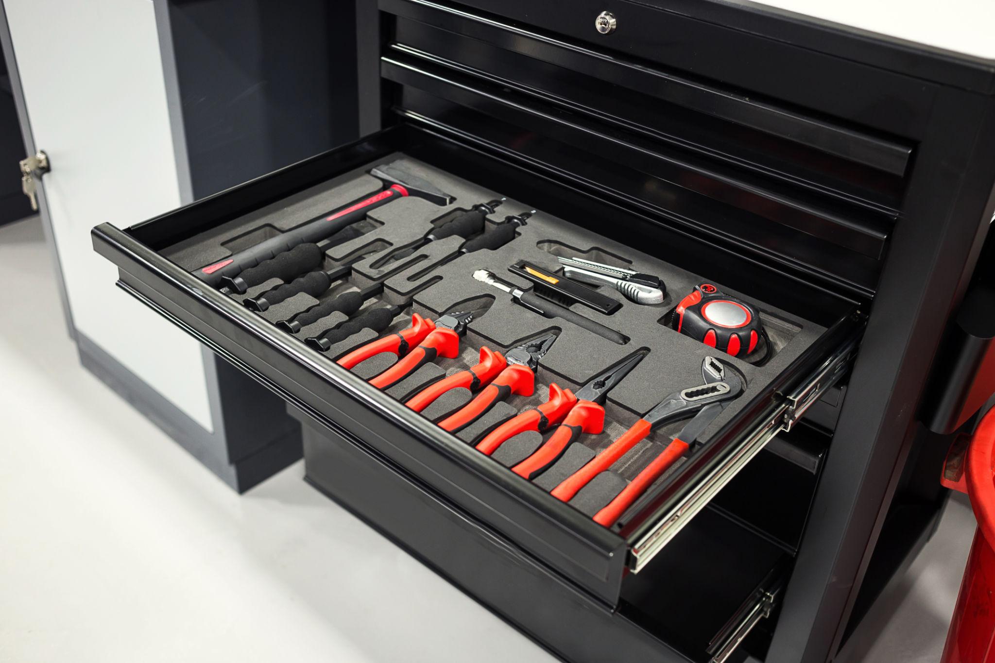 Organized mechanic tool storage — professional tool chest with socket sets, wrenches, and specialty tools arranged in labeled foam-lined drawers