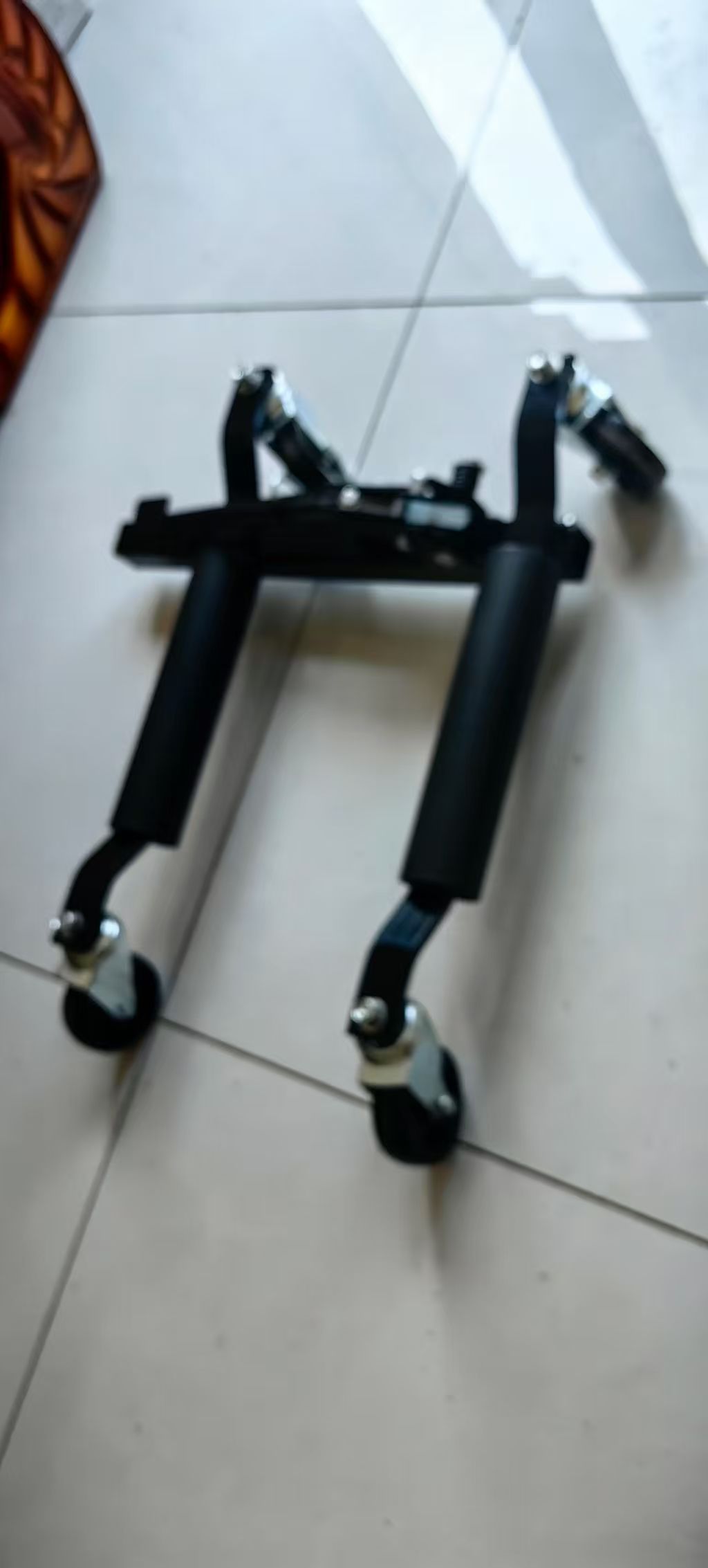 Soft-focus overview of the supplied black vehicle positioning dolly