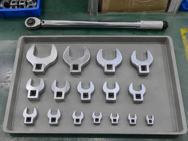 Crowfoot adapters organized by apparent size with a wrench separate