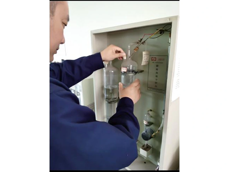 Operator using carbon and sulfur analysis equipment