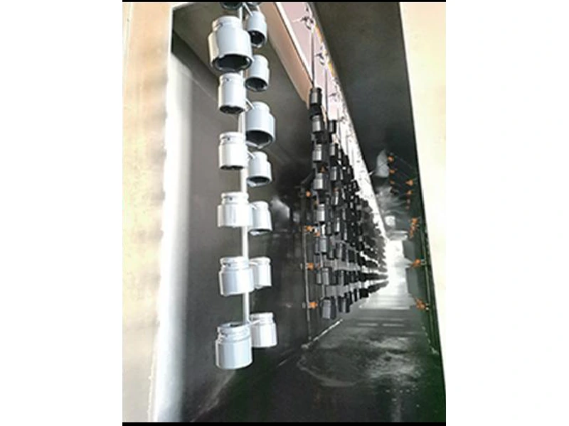 Coated parts hanging from a production line
